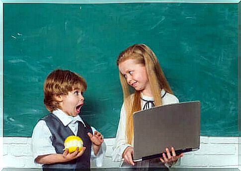 small children standing at a blackboard