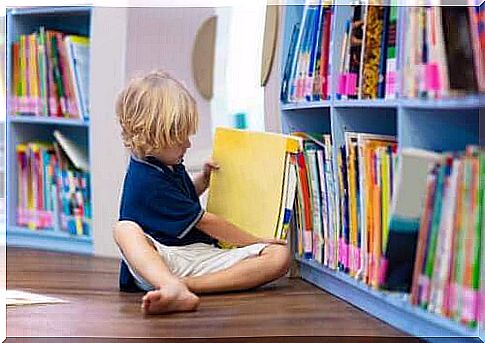 child who has taken a folder out of the bookshelf