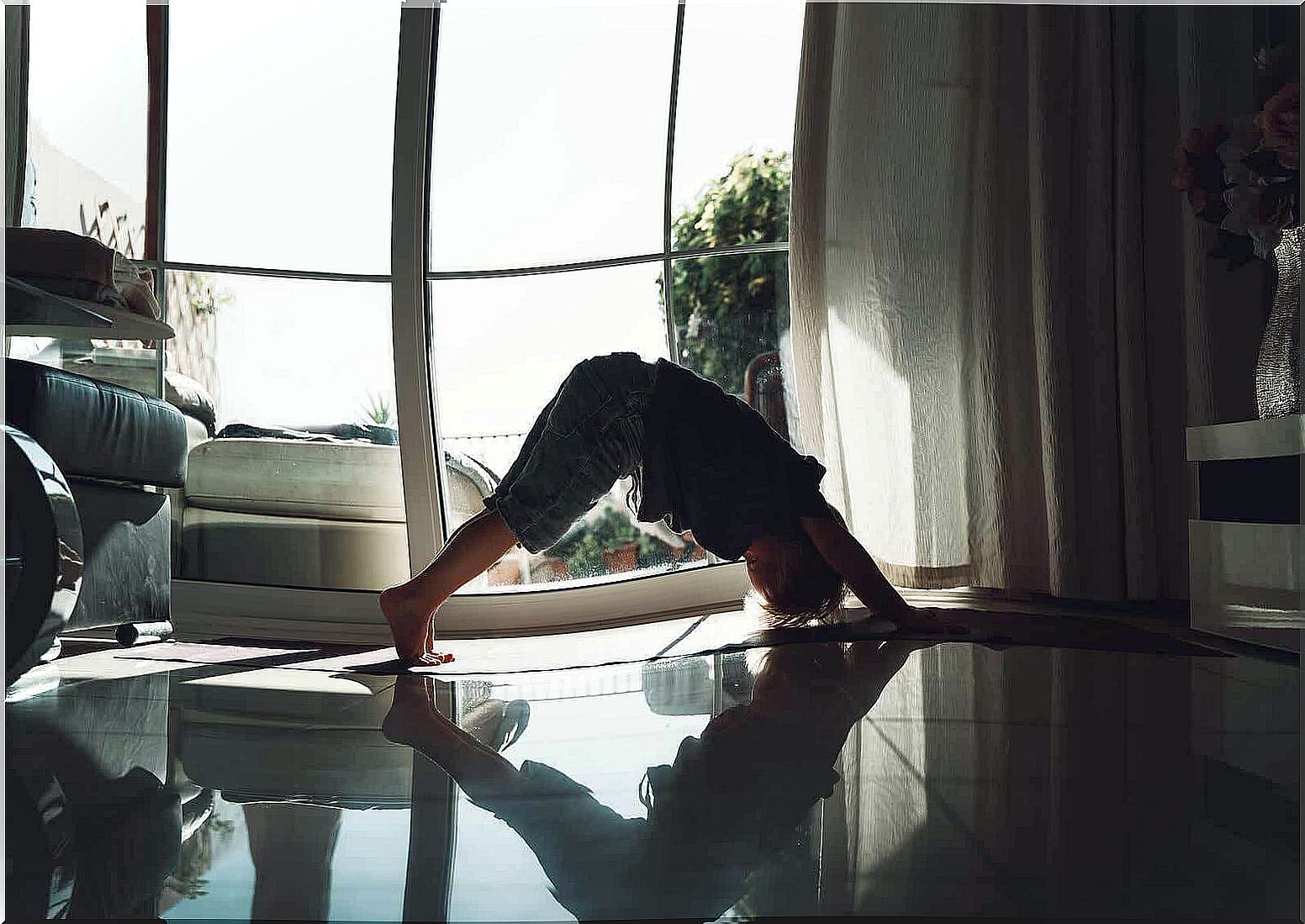 A little boy performing yoga exercises