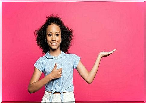 girl standing by pink wall