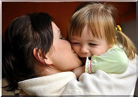 Mother kisses daughter