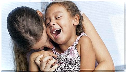 Mother hugs her happy daughter