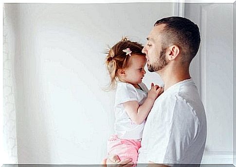 father standing with little girl