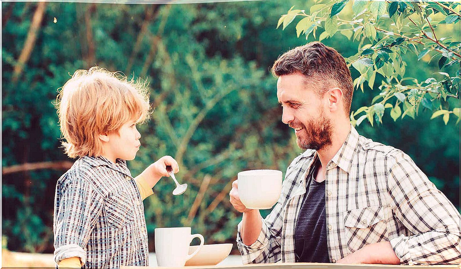 A father drinking coffee with his son