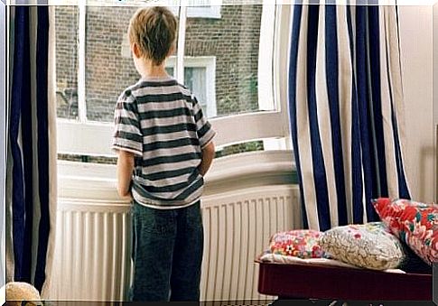 little boy looking out of a window