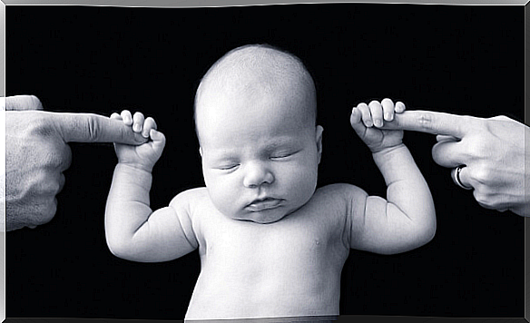 Baby holds parents in his hands