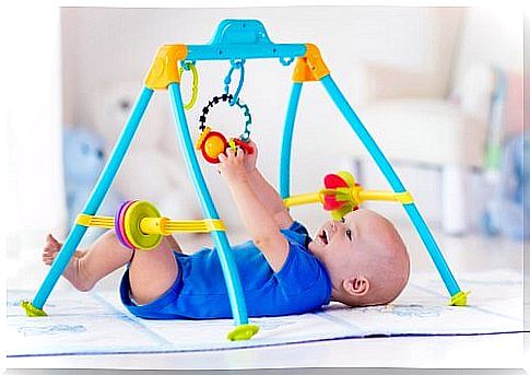 baby playing with stand