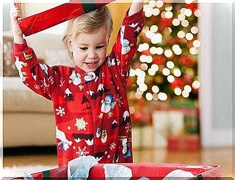 Excited child opens Christmas presents