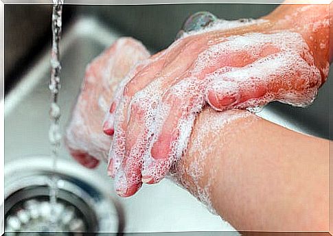 person washing hands thoroughly with soap