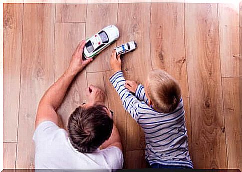 father and son playing with cars