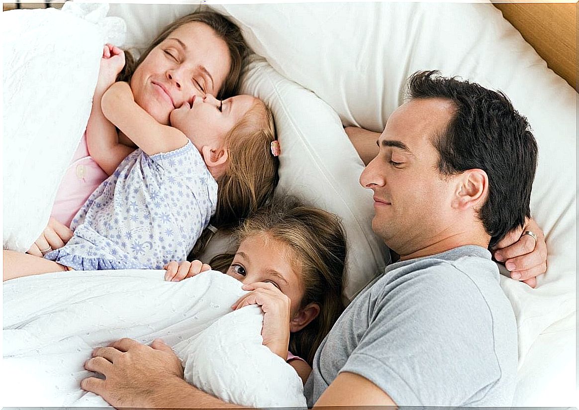 family putting together in bed