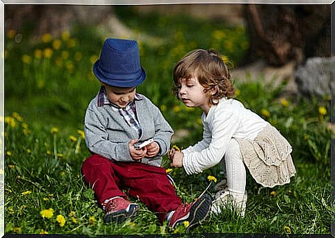 little girl interested in a little boy's toy