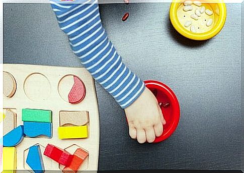 child taking beans from bowl