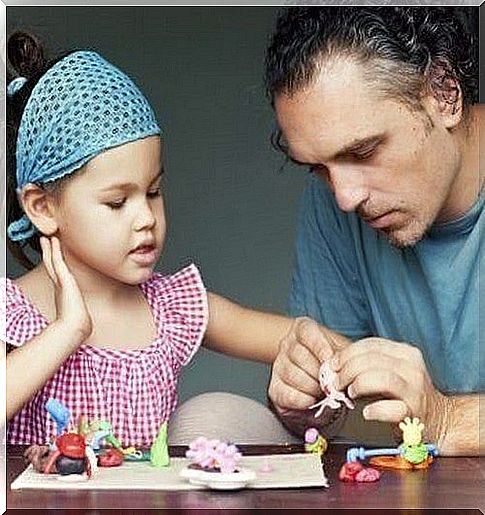 father and daughter playing with toys