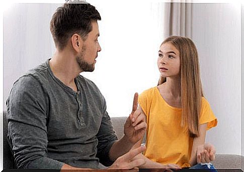 father talking to young daughter