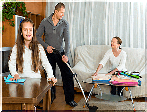 Daughter helps mom and dad with the cleaning in the home