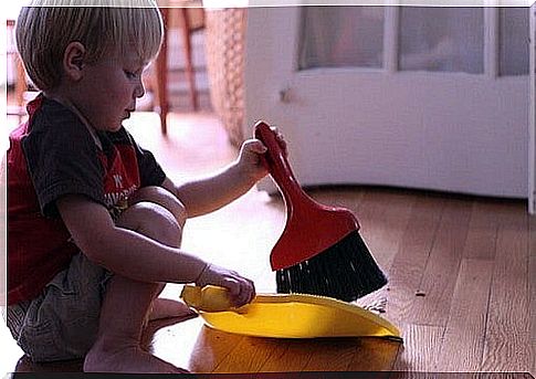 Boy helps by sweeping the floor