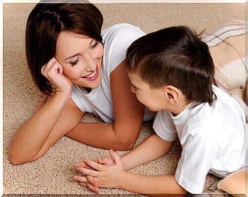 mother and boy lying on carpet