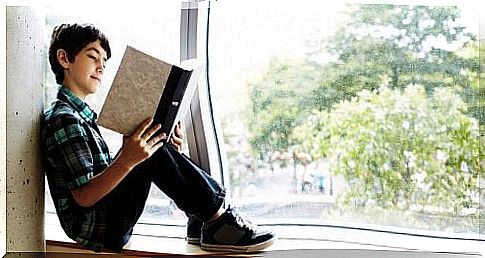 boy reading in book