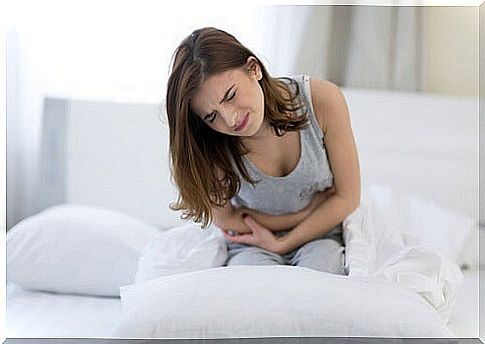 woman in sofa with stomach pain