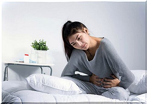 woman in bed with abdominal pain