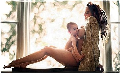 Mom sits and breastfeeds baby