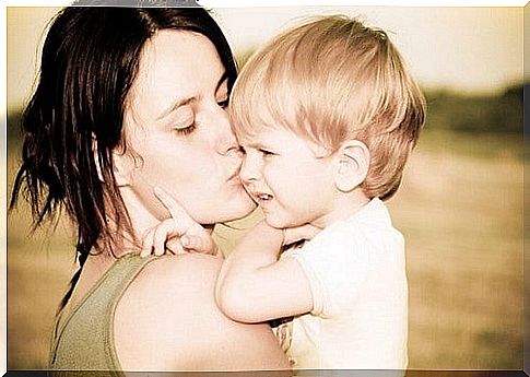 child gets kiss by mother