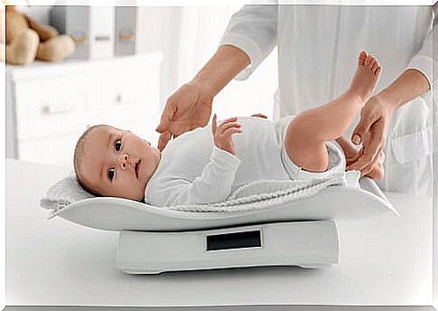 baby being weighed on table scale