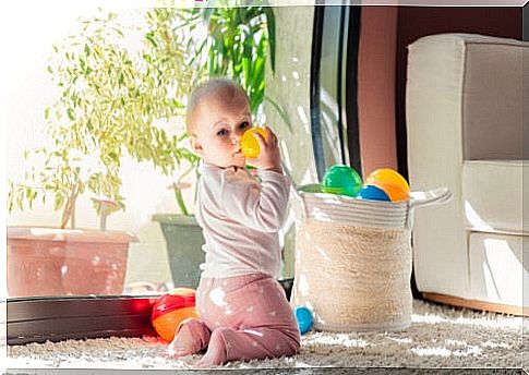 Girl with balls as part of Montessori games for children from 0 to 3 years