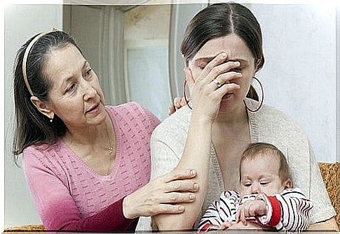 mother with baby being comforted by friend