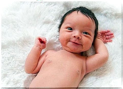 newborn baby smiles to the world