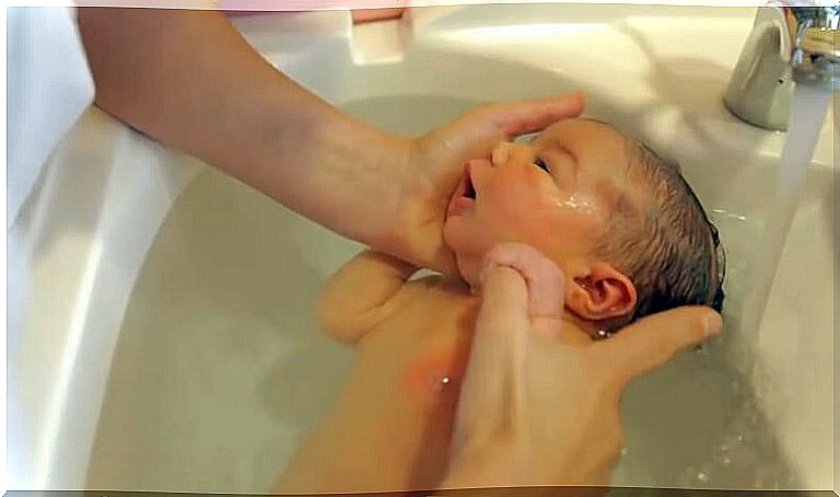 Baby is bathed as part of caring for newborns