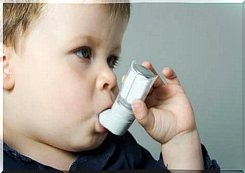 little boy using inhaler