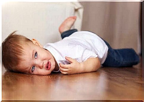 little boy lying on floor