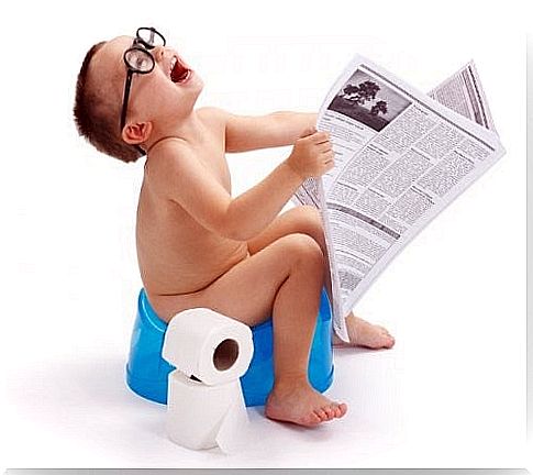 boy reading newspaper on the pot