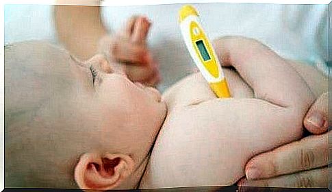 baby gets his temperature measured