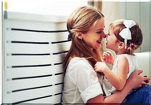 mother and little girl having nose to nose