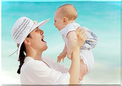 mother with baby on the beach