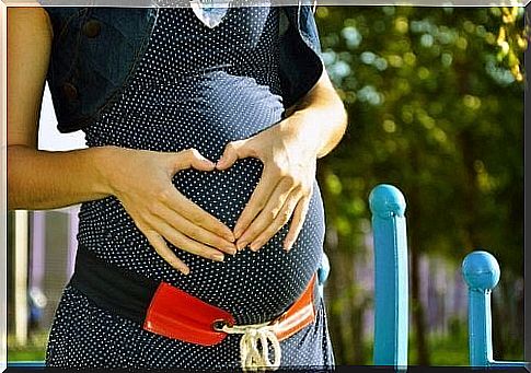 Pregnant woman holding on to belly