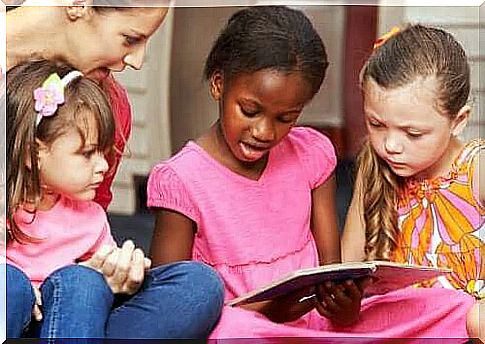 little girls reading with adult