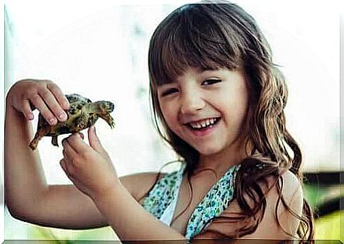 Girl holding a turtle