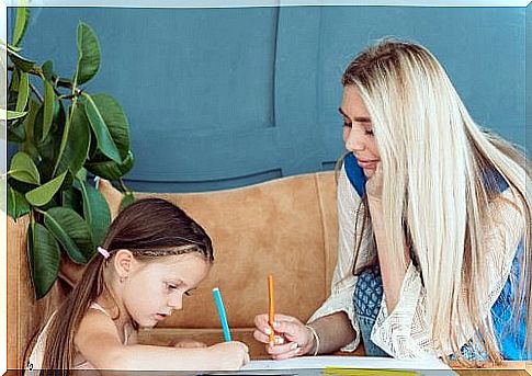 mother and daughter writing on paper