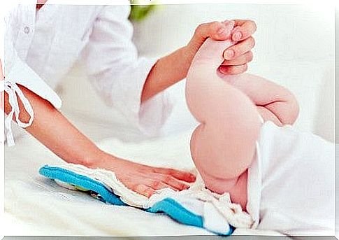 Woman changing diaper on baby