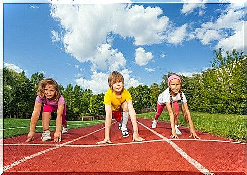 three children ready for running on the track